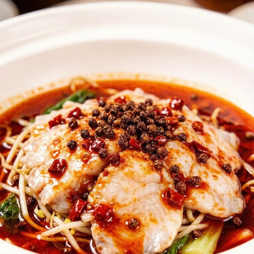 Poached fish slices in a spicy chilli-oil bowl